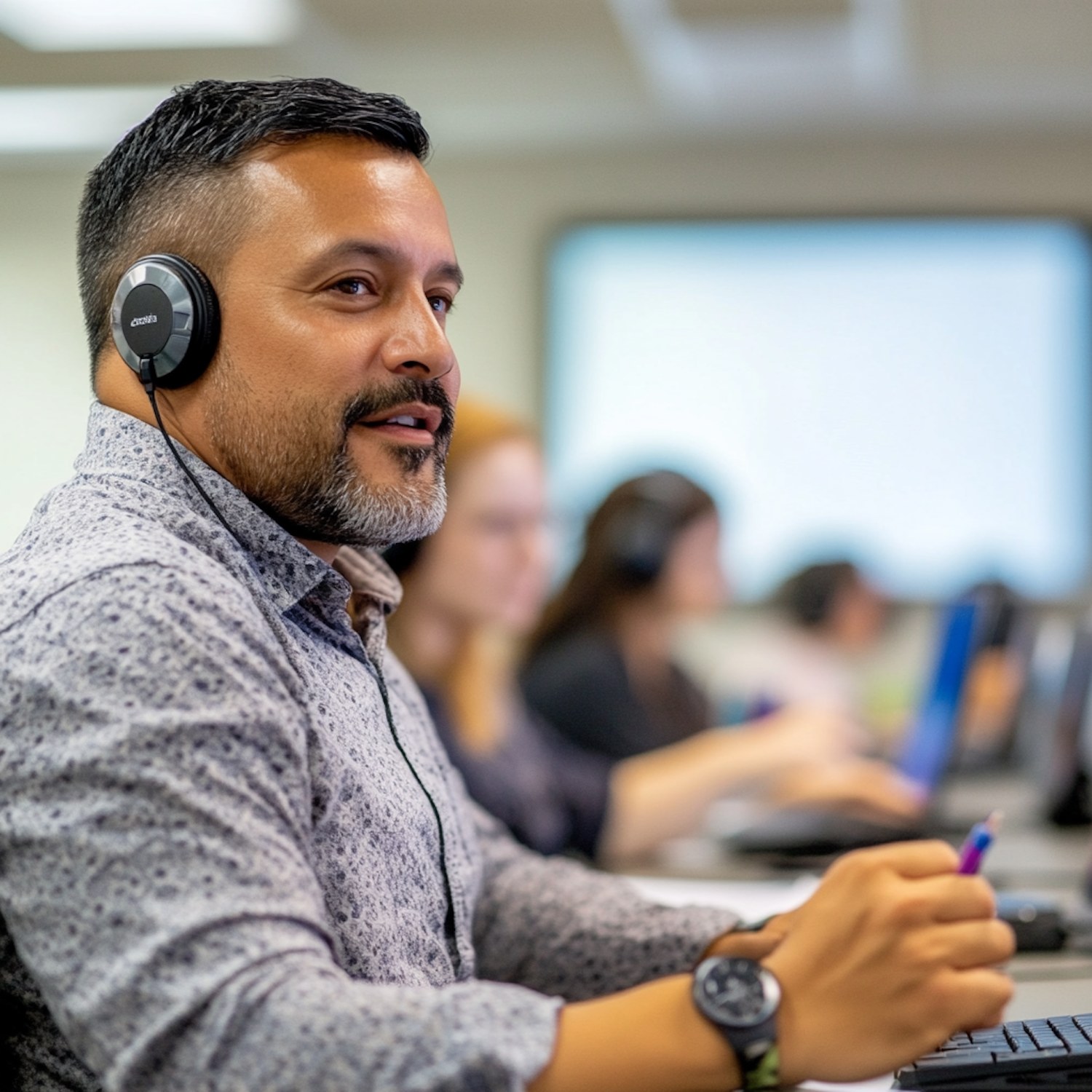 A focused individual wearing headphones, engaged in online learning on a computer, demonstrating the pursuit of sales certifications to enhance skills.