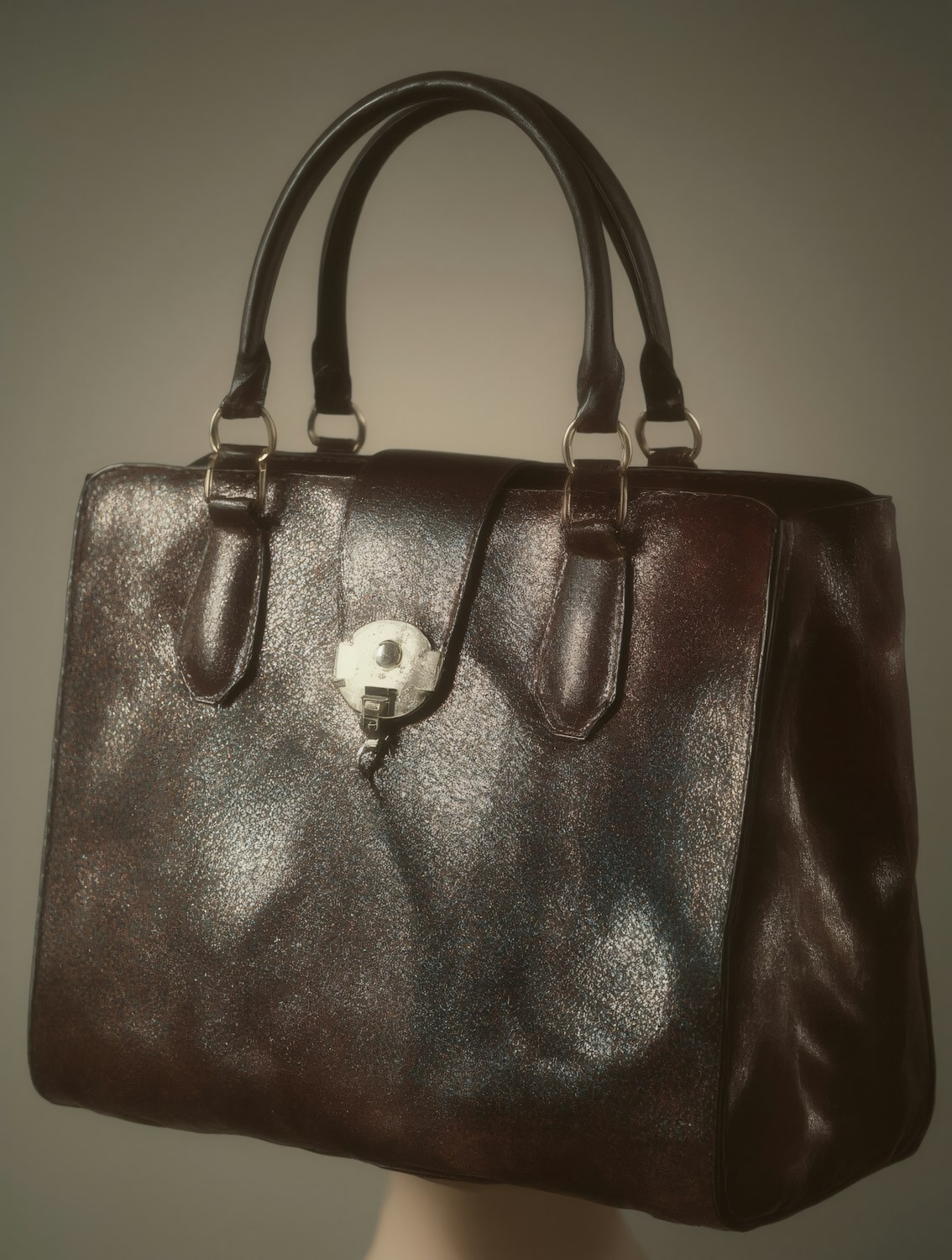 A person carefully examining a vintage Coach bag in a thrift store, illustrating the process of sourcing valuable resale items.
